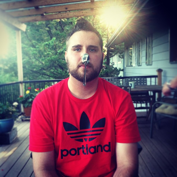 profile picture of man on patio with spoon on nose